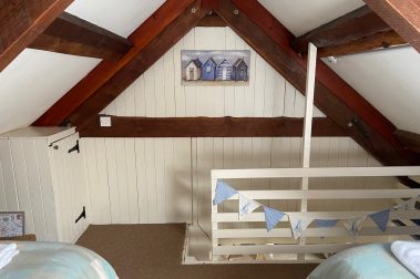 The twin bedroom with view of the steep stairs