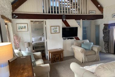 The sitting room with view up to galleried king-sized bedroom