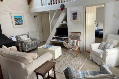 The cosy living room is open plan and has a light, bright feel. It is overlooked by the mezzanine bedroom above. The bathroom and downstairs double bedroom open directly into the living room.