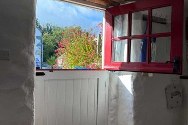 The kitchen has a stable door and overlooks the patio.
