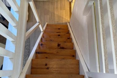The stairs to bedroom two, situated on the mezzanine floor, are steep, open and unguarded. They pass directly up from the sitting room, close to the bathroom door