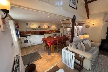 The cottage has an open plan living area and kitchen appliances include a freestanding electric cooker with ceramic hob, fridge-freezer, microwave, dishwasher and washer-dryer. Cafetieres and teapots are supplied.