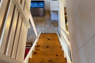 The twin bedroom above the kitchen is accessed via a steep, open and unguarded staircase.