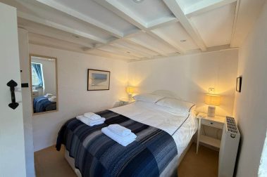 The downstairs bedroom has a comfortable king sized bed and is warm and cosy.